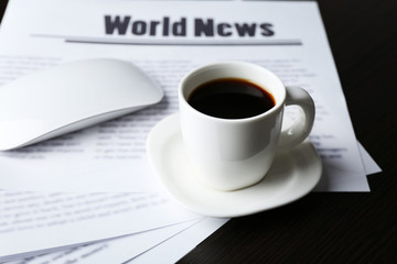 On-line news concept. Computer mouse, cup of coffee and
