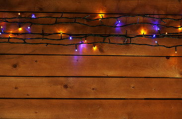 Christmas lights garland on wooden background