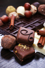 Bars of white and bitter chocolates with candies, hazelnut and