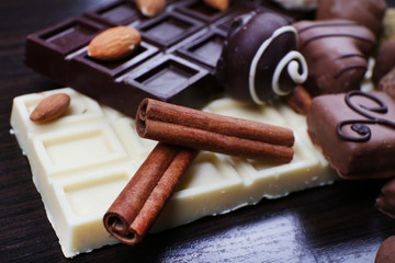 Bars of white and bitter chocolates with candies, cinnamon