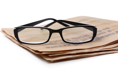 Glasses and newspapers, isolated on white