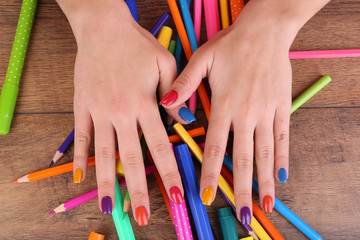 Multicolor female manicure with markers and pencils