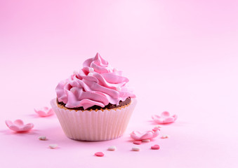 Delicious cupcake on pink background