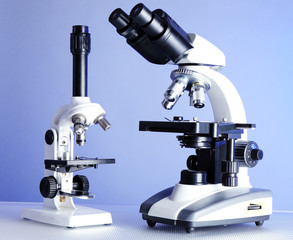 Microscopes on table, on color background