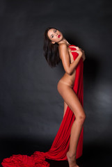 Obraz premium Nude body covered with a reb fabric