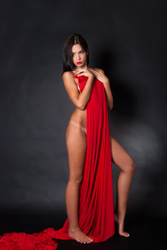 Fototapeta Nude body covered with a reb fabric