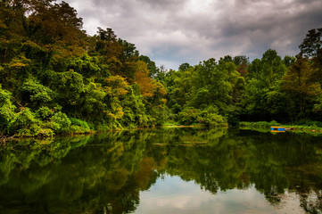 Obraz premium Trees and storm clouds reflecting in a pond in York County, Penn