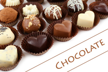 Delicious chocolate candies on white background