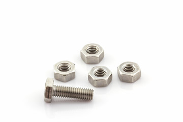 Metal screw and nuts on white background.
