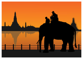 Silhouetted of tourists on an elephant