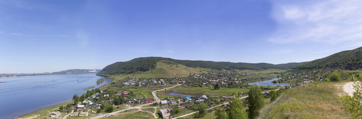 Fototapeta na wymiar The settlement on the banks of the great river, panorama