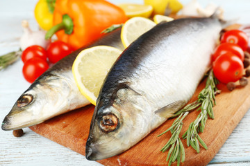 Fresh raw fish and food ingredients on table