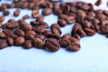 Coffee beans on the blue wooden background