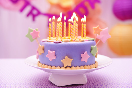 Delicious birthday cake on table on bright background