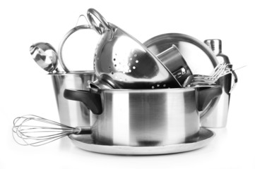 Stainless steel kitchenware on table, isolated on white