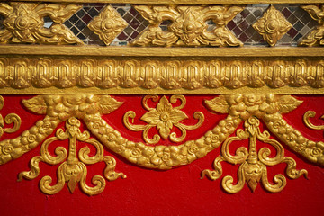 wall carving art with stained glass in the temple ,Thailand