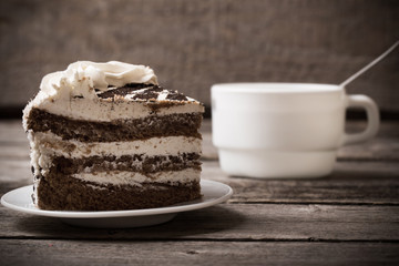 cup  and cake on old wooden background