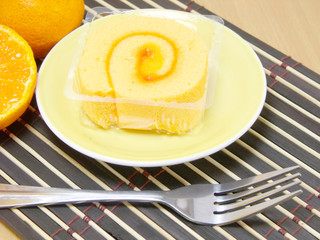 sponge roll cake with orange cream and fresh mandarin