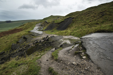 Landscape of collapsed A625 road in Peak District UK