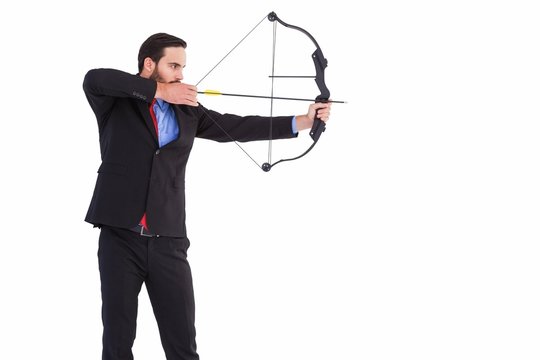 Focused Businessman Shooting A Bow And Arrow