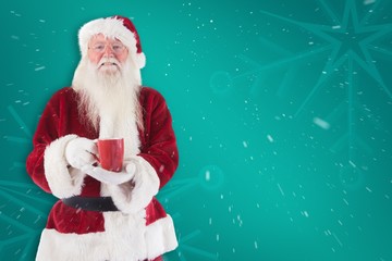 Composite image of santa holds a red cup