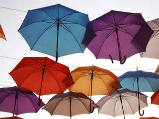 Lots of umbrellas coloring the sky