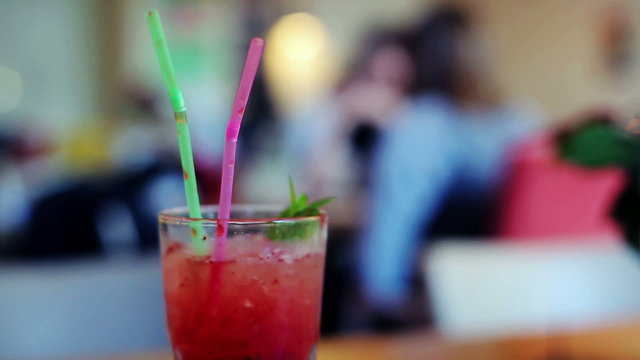 Close up of fruity, strawberry tropical, cocktail with straw