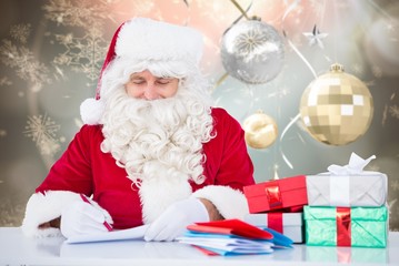 Composite image of santa writing cards