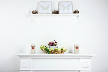 Stylish shelves with candles and frames