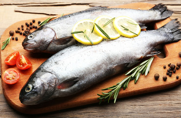 Fresh raw fish and food ingredients on table