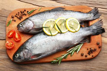 Fresh raw fish and food ingredients on table