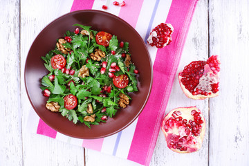 Fresh salad with greens, garnet and spices