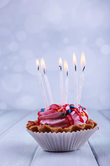Birthday cup cake with candles and sparkles