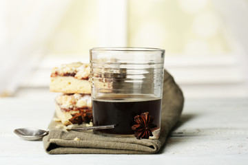 Glass of espresso and tasty homemade pie on wooden table
