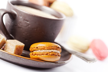 Cup of coffee and macaroons on white background, toned