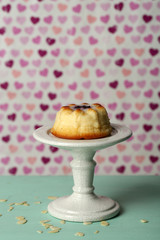 Delicious cheesecake on wooden table, on color background