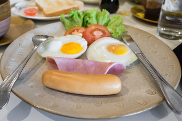 English breakfast with fried eggs, bacon, sausages,