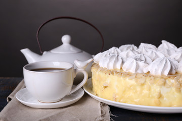 Tasty homemade meringue cake and cup of tea