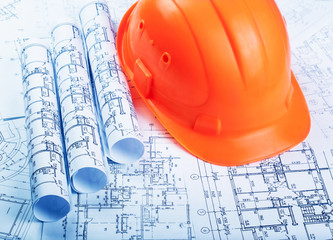 Architectural blueprint rols and helmet
