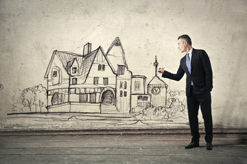Businessman drawing a house