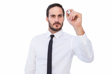 Focused businessman writing with marker