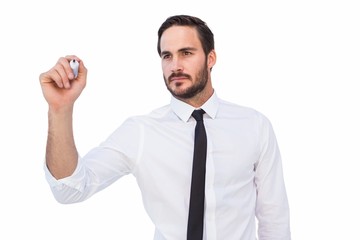 Focused businessman writing with marker