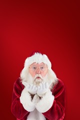Composite image of santa claus blows something away