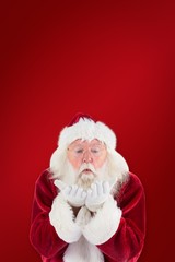 Composite image of santa claus blows something away