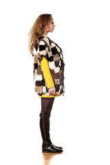 side view young woman in a short fur coat without sleeves