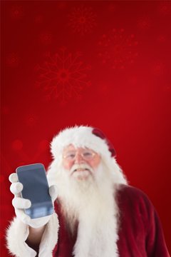 Composite image of santa claus shows a smartphone