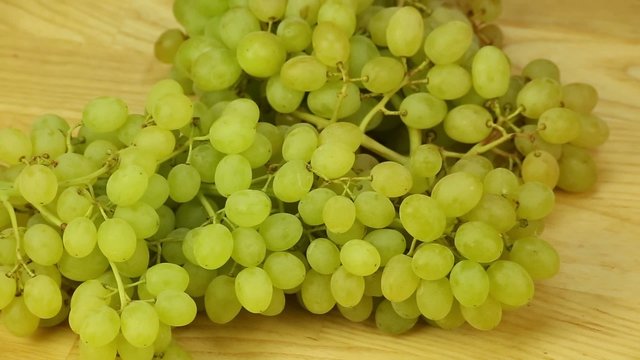 Hron grapes rotates on a wooden boards background