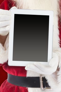 Composite image of santa claus showing tablet pc
