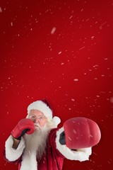 Composite image of santa claus punches with his right