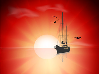 Silhouette of a sailing vessel and seagulls in sea on sunrise